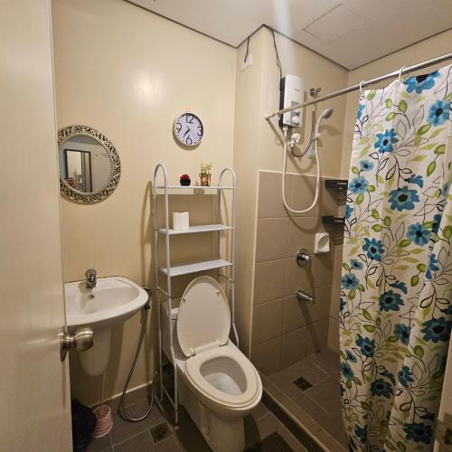 a small bathroom with a toilet and a sink at Avida Davao condo Studio type in Davao City