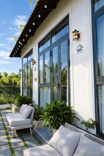 a home with large windows and a patio at Hoàng Đô Hotel in Phú Quốc