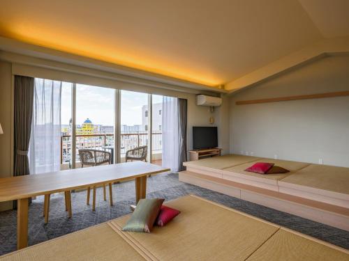 a bedroom with a large bed and a large window at TATAMI NO YADO Chatan Mihama by COLDIO in Chatan