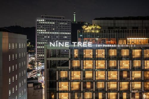 a nine tree sign on the top of a building at Nine Tree by Parnas Seoul Myeongdong 2 in Seoul