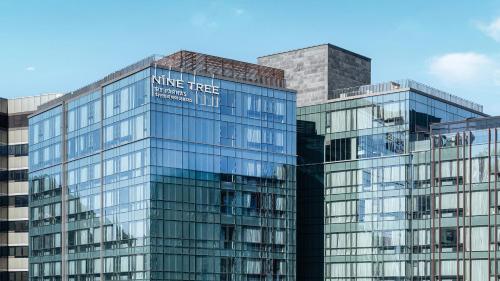 two tall glass buildings next to each other at Nine Tree by Parnas Seoul Insadong in Seoul
