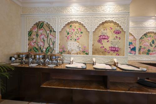 a bathroom with a counter with a floral wallpaper at Ved Mahal in Jaipur