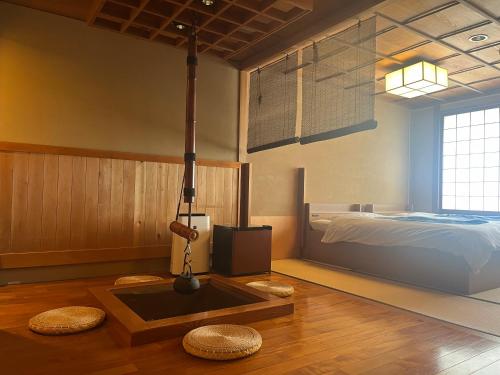 a bedroom with a bed and a tv in it at 旬樹庵　菊水 in Chikuma