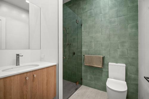 a bathroom with a toilet and a sink and a shower at Harborview Modern Studio 11F in Victor Harbor