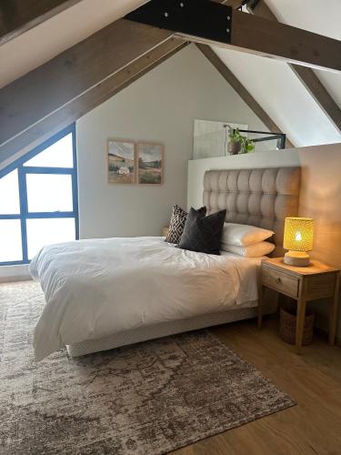 a bedroom with a large bed in a attic at Fallen Oak Villa 2 in George