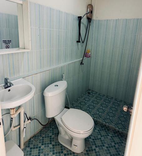 a bathroom with a toilet and a sink at Happiness Hostel Private room in Phra Ae beach