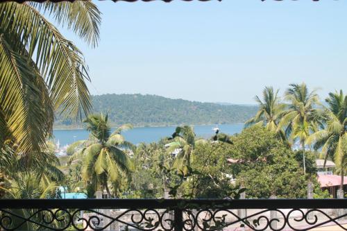 a view from the balcony of a resort with palm trees at Ocean Terrace in Port Blair