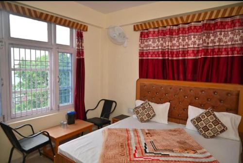 a bedroom with a bed and a red curtain at The Boho BNB in Shimla