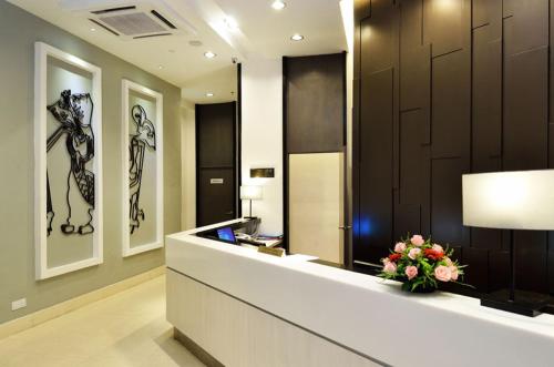 a lobby with a reception desk with a vase of flowers at Holiday Villa Hotel & Suites Kota Bharu in Kota Bharu