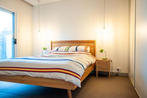 a bedroom with a bed and a window at Eco Retro Aldinga Beach House in Aldinga Beach