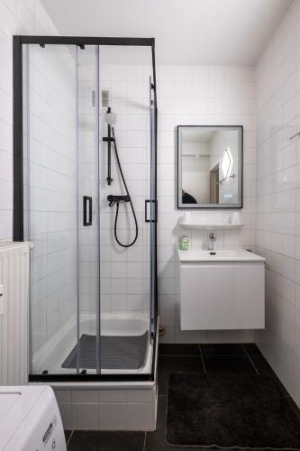 a bathroom with a shower and a sink at Appartement Ann in Blankenberge