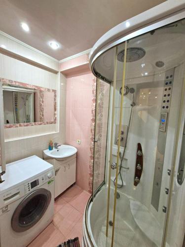 a bathroom with a shower and a sink at Apartments Chisinau in Chişinău