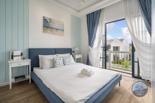a bedroom with a large bed and a large window at CASA Villa NOVAWORLD Phan Thiet in Phan Thiet