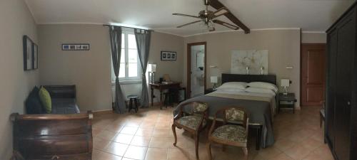 a bedroom with a bed and a table and chairs at Locanda La Pergola in Bellagio