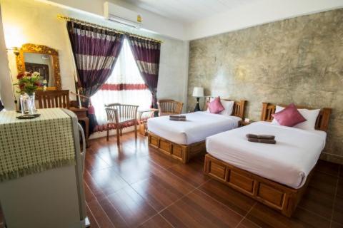 Katil atau katil-katil dalam bilik di รีสอร์ทที่ลำปาง (Resort At Lampang)