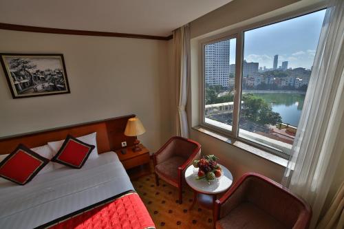 a hotel room with a bed and a large window at Sunny Hotel 1 in Hanoi