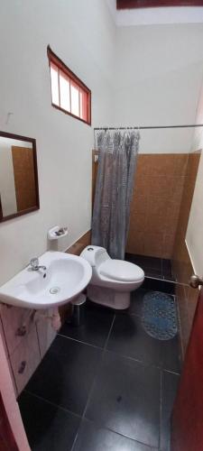 a bathroom with a sink and a toilet and a shower at Mítica, Casa Hospedaje in Sauce