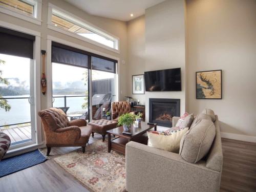 a living room with two couches and a fireplace at Amazing Oceanfront & Eagle Views pet Friendly - 2 bath in Port Renfrew