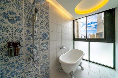 a bathroom with a toilet and a window and a sink at Sunlight Heyun B&B in Yuanshan