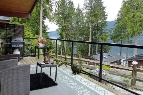 a balcony with a view of the water at Tiltin Hilton- Ocean View - Pet Friendly - sleep 4 in Port Renfrew