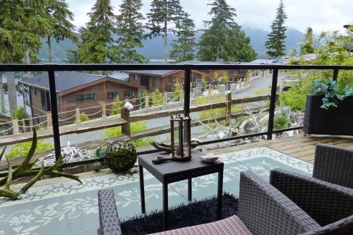 a balcony with a view of a house at Tiltin Hilton- Ocean View - Pet Friendly - sleep 4 in Port Renfrew