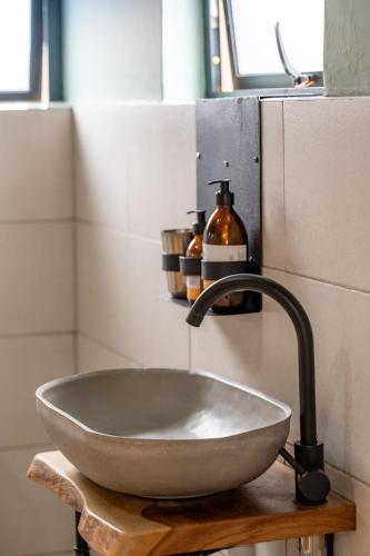 a bowl sink in a bathroom with a faucet at The Drift Cottage in Livingstone