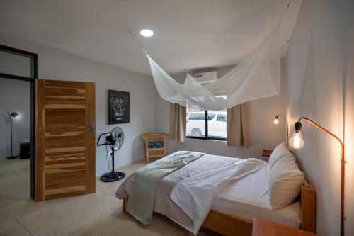 a bedroom with a bed with a mosquito net at The Drift Cottage in Livingstone