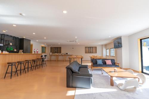 a living room with a couch and a table at 苗場サンバレーホテル in Minami Uonuma