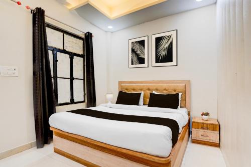 a bedroom with a large bed and a window at OYO Hotel O Subedarganj Railway Junction Formerly Krishna Inn in Prayagraj