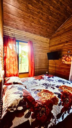 a bedroom with a large bed in a room with a window at Cabaña Colibrí - Parking in Sarchí