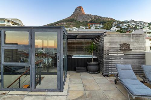 a glass house with a view of a mountain at Namaste in Cape Town