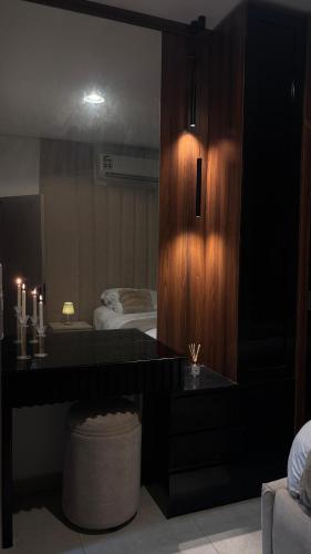 a bedroom with a desk and a bed and a mirror at Alaziba view in ‘Udhaybah
