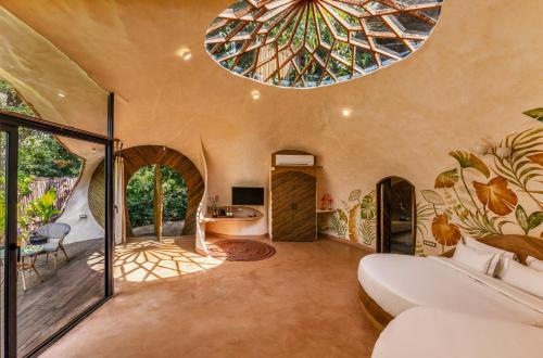 a bedroom in a house with a ceiling at Eleve in Assagao