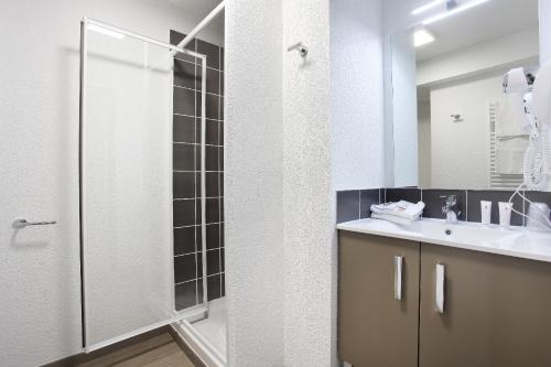 a bathroom with a shower and a sink at Appart Hotel Odalys City Marseille Le Dôme in Marseille