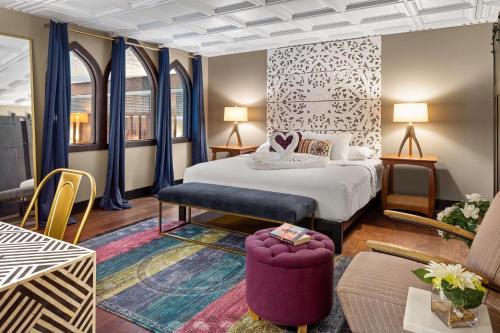 a hotel room with a bed and a couch at The Highlander Hotel, Ascend Hotel Collection in Iowa City