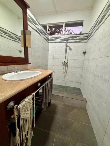 a bathroom with a sink and a shower at Perle rare Lodge in Diamond Island