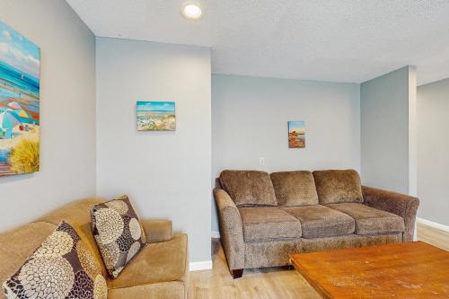 a living room with a couch and a table at Sea Treasures Inn #114 in Rockaway Beach