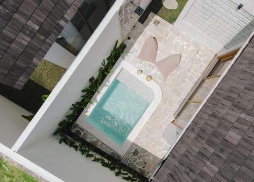 an overhead view of a swimming pool on a house at Palm Valley Loft in Kuta Lombok