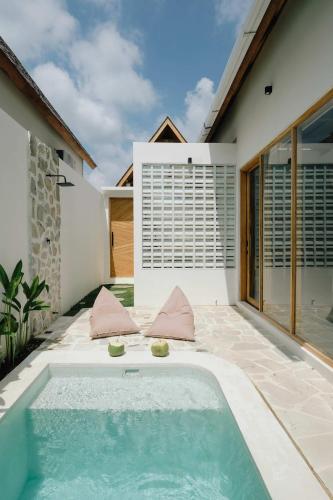 a pool in the backyard of a house at Palm Valley Loft in Kuta Lombok