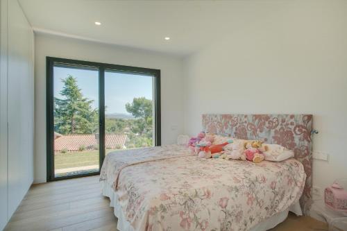 a bedroom with a bed with stuffed animals on it at Villa Rubi in Platja d'Aro
