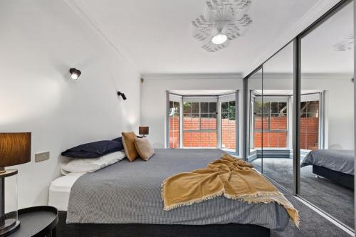a bedroom with a bed and a large window at The Laneway - 3BR, Pet Friendly, Walk to CBD in Port Lincoln