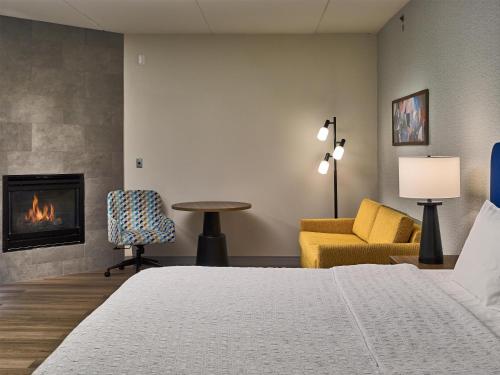 a hotel room with a bed and a fireplace at Hampton Inn Pigeon Forge in Pigeon Forge