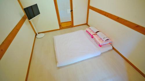 a room with a bed and a lamp on the floor at Hanok Onew in Jeonju