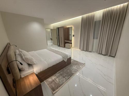 a bedroom with a bed in a room with marble floors at نسيم العلا - Naseem AlUla in Al-ʿUla