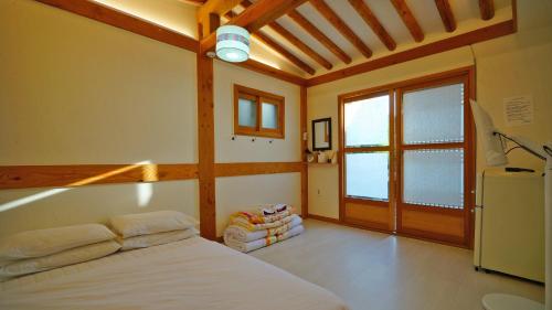 a bedroom with a white bed and a window at Hanok Onew in Jeonju