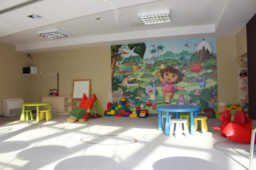 a play room with a mural on the wall at Wellness Apartments in Velence in Velence