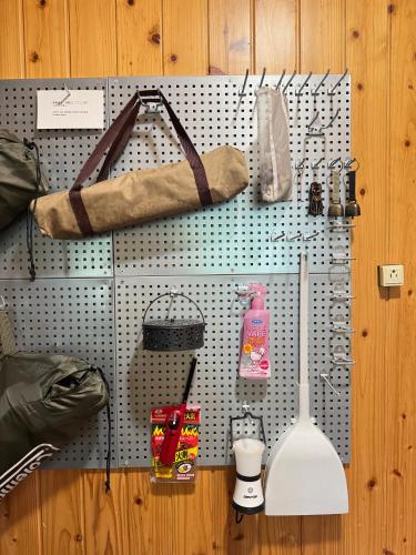 a wall with a pegboard with various items on it at 嬉々の屋KIKI Chalet in Hakuba