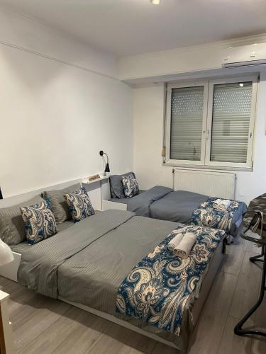 a bedroom with two beds and a couch at Old Bazaar City Center Apartment in Skopje