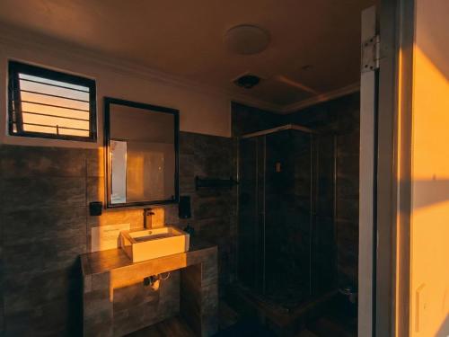 a bathroom with a sink and a shower at Picasso - Zur See in Ballito