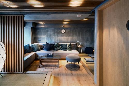 a living room with a couch and a table at Oootopia Tai Kok Tsui in Hong Kong